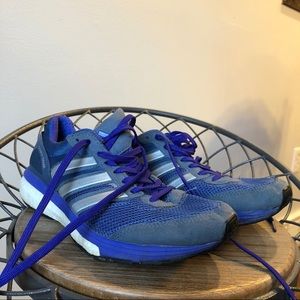 blue adidas running shoes / sneakers
